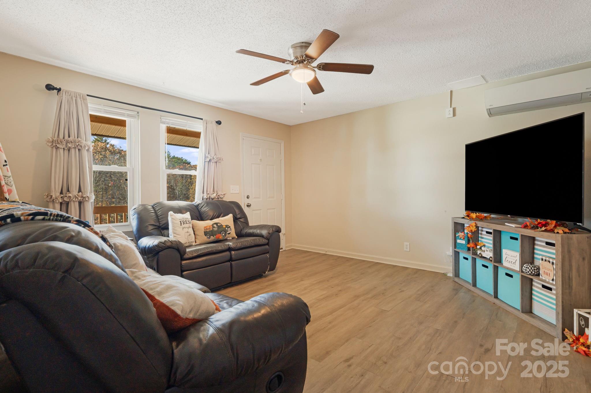 645 Flint Hill Road Alexander, NC 28701 - Photo 16 of 30 a living room with furniture and a flat screen tv