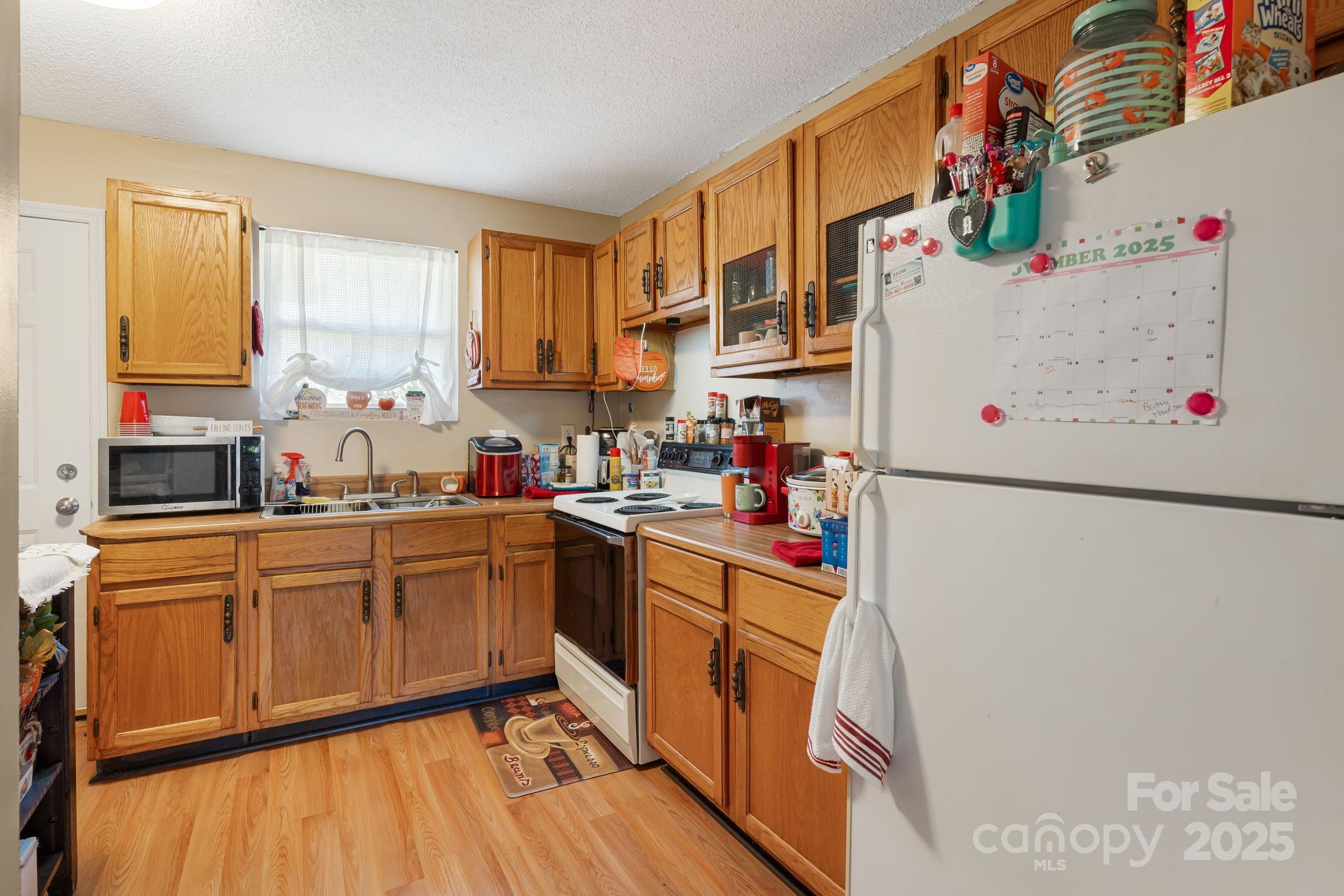 645 Flint Hill Road Alexander, NC 28701 - Photo 17 of 30 a kitchen with cabinets a sink and white appliances