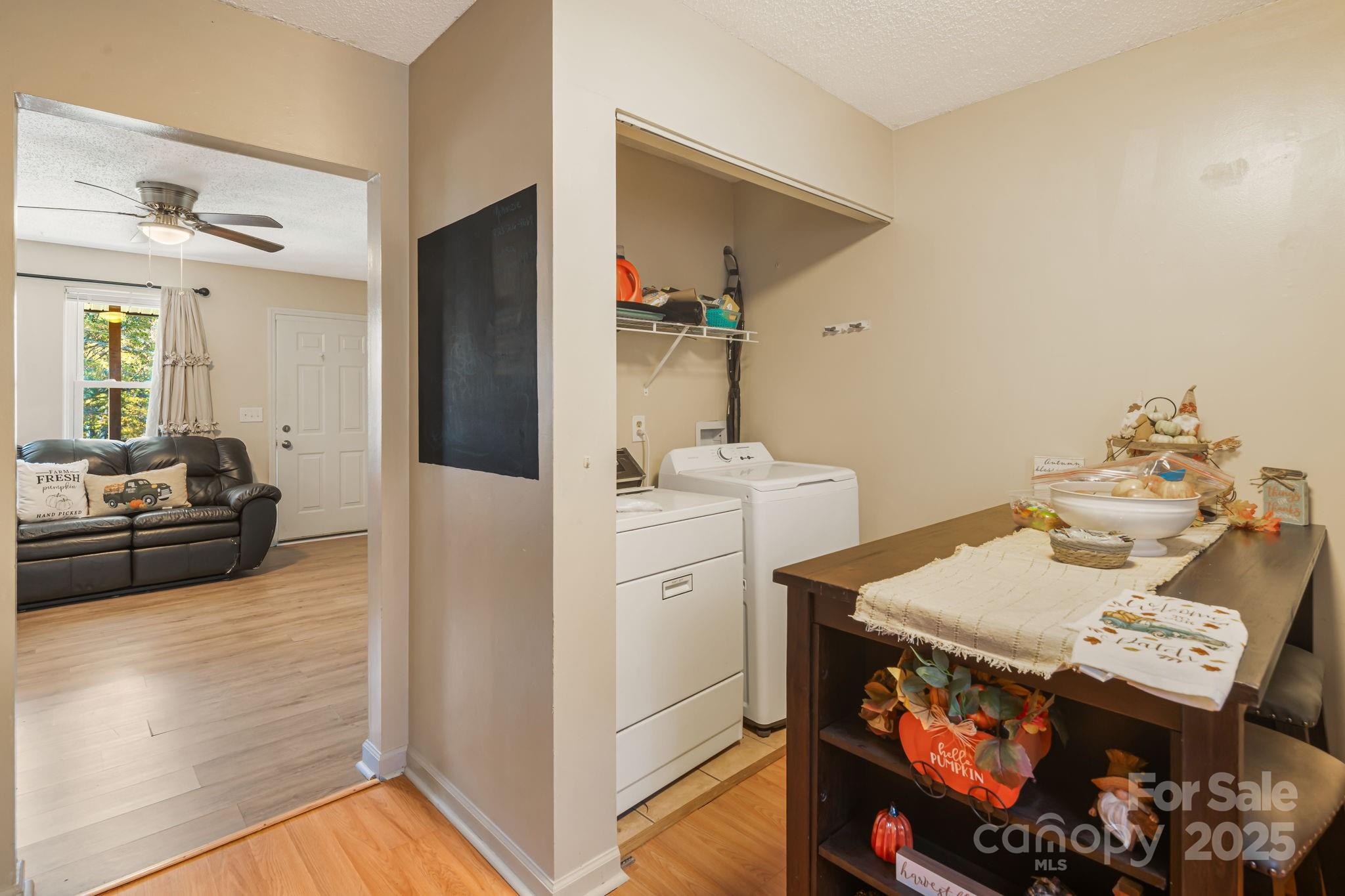 645 Flint Hill Road Alexander, NC 28701 - Photo 19 of 30 a view of kitchen island with furniture and wooden floor