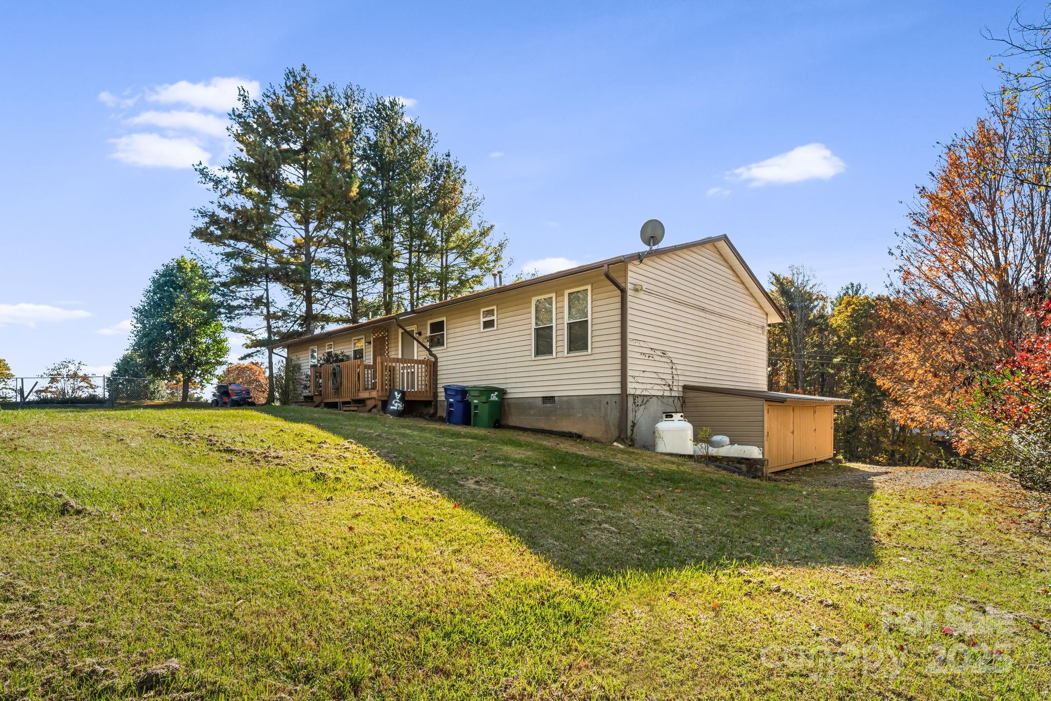 645 Flint Hill Road Alexander, NC 28701 - Photo 27 of 30 a view of a house with a yard and garage