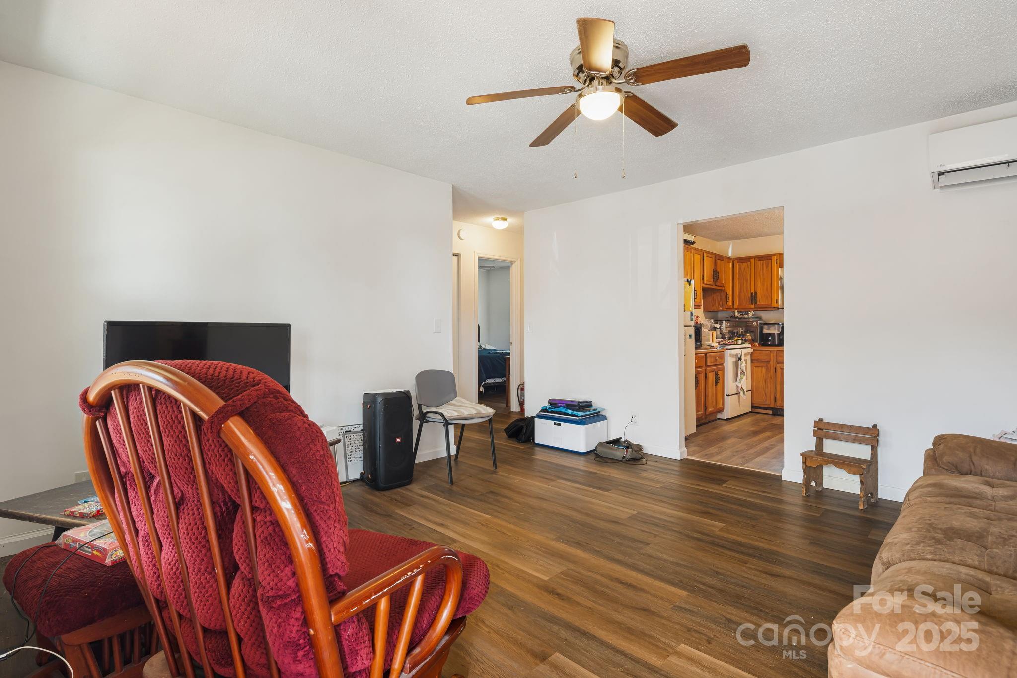 645 Flint Hill Road Alexander, NC 28701 - Photo 3 of 30 a living room with furniture a ceiling fan and a rug
