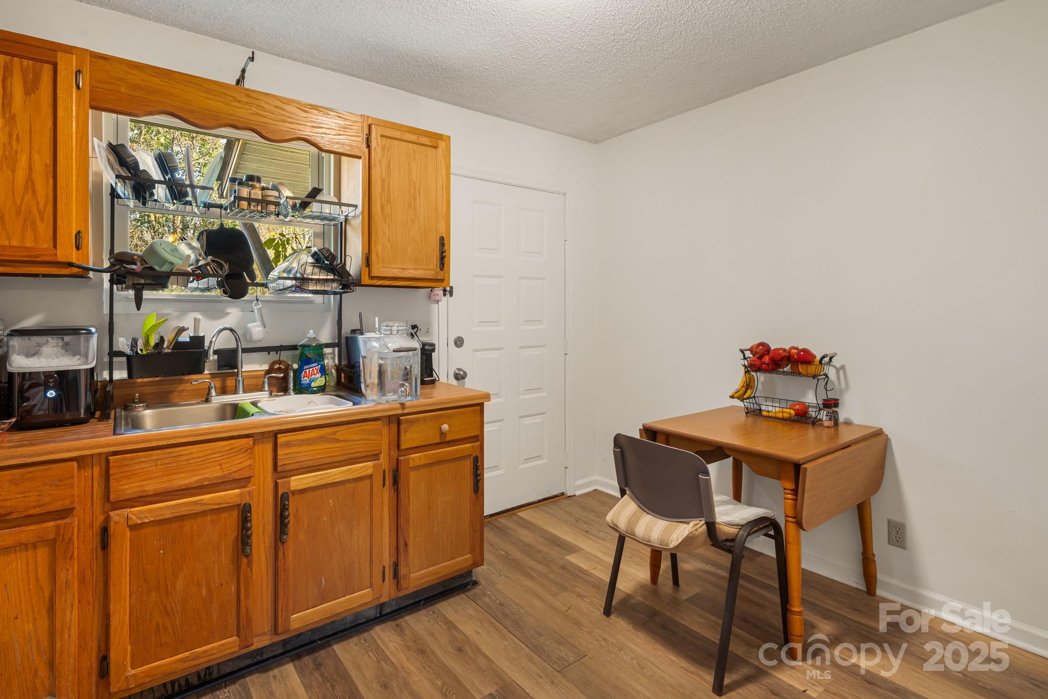 645 Flint Hill Road Alexander, NC 28701 - Photo 6 of 30 a kitchen with stainless steel appliances wooden cabinets and a stove top oven