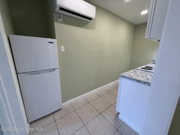 a kitchen with a refrigerator and a stove
