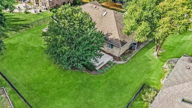 an aerial view of a house with a yard