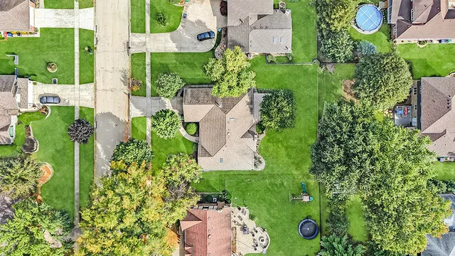 an aerial view of a house with a yard basket ball court and outdoor seating