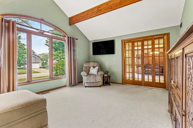 a bedroom with furniture and a large window
