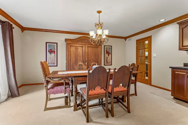 a view of a dining room with furniture and chandelier