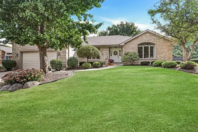 a view of a house with a yard and sitting area