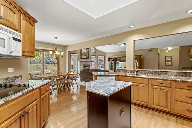 a kitchen with center island table and chairs in it