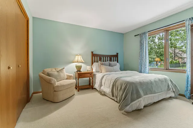 a spacious bedroom with a bed and a couch