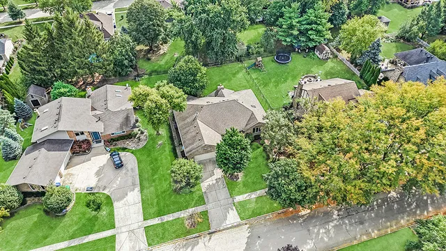 an aerial view of a house with garden space and street view