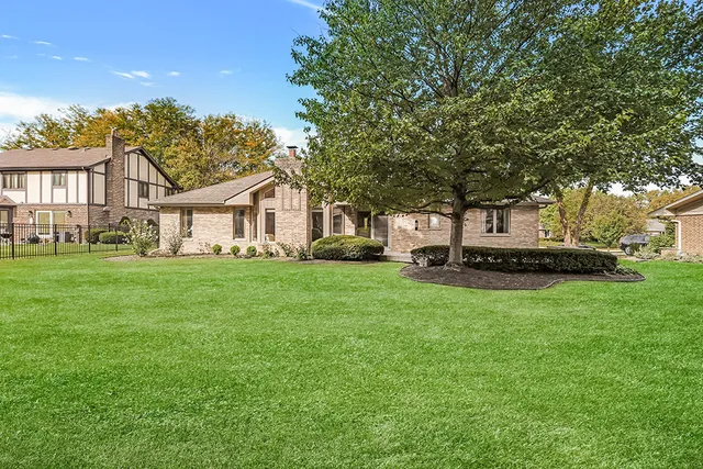 a view of a house with backyard sitting area and garden