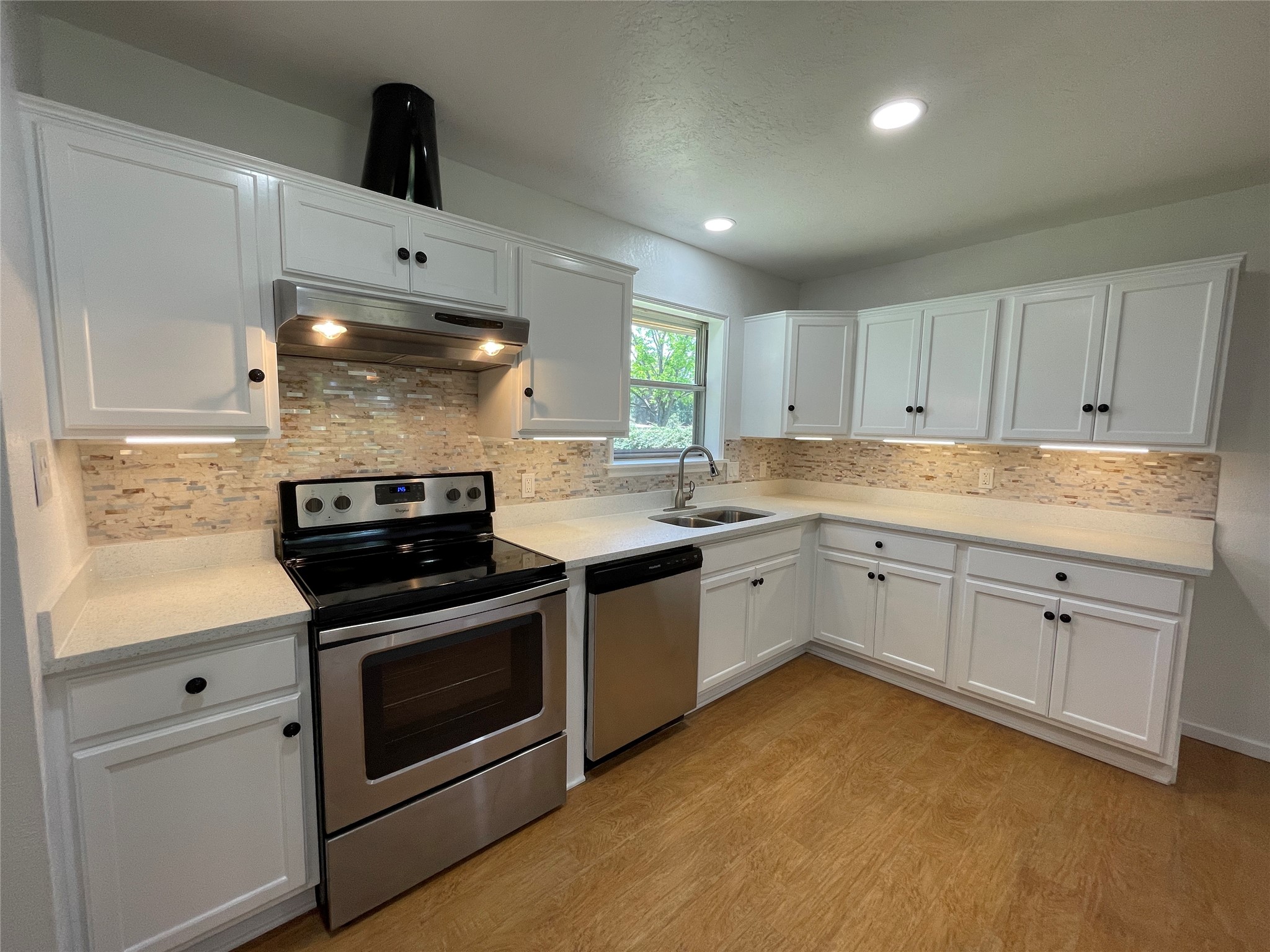 19439 Keenan Cut Off Road Montgomery, TX 77316 - Photo 12 of 39 Freshly remodeled kitchen features elegant quartz countertops and stylish under-cabinet lighting, creating a sleek and inviting space for culinary delights.