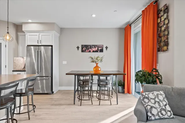 a view of a dining room with furniture and a potted plant