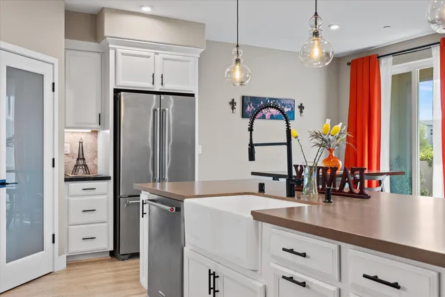 a kitchen with stainless steel appliances granite countertop a refrigerator and a sink