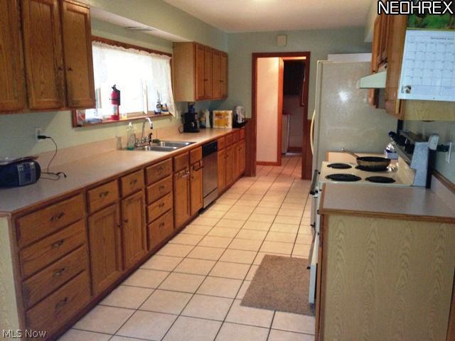 9809 Johnnycake Ridge Road Mentor, OH 44060 - Photo 3 of 18 Large kitchen with ceramic tile floors. All appliances are included. Also a very nice size laundry room just past kitchen.