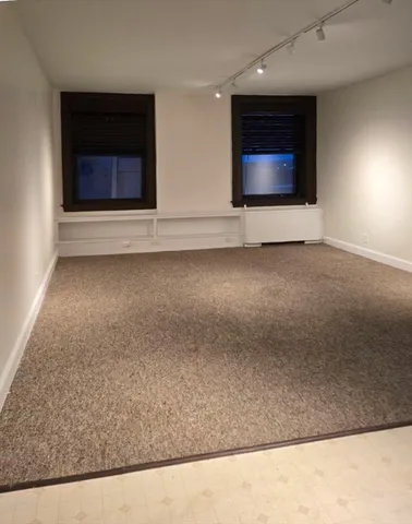 a living room with a rug and a fireplace