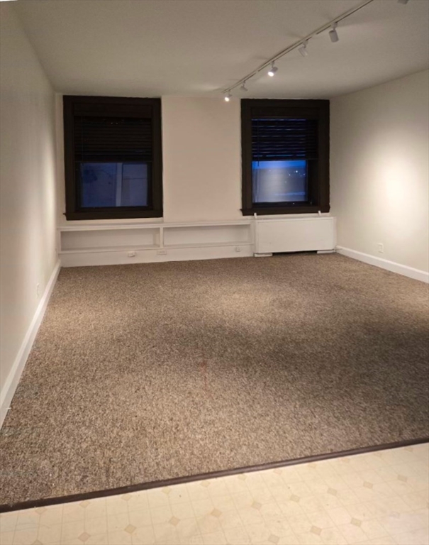 140 Chestnut Street, Unit 816 Springfield, MA 01103 - Photo 3 of 10 a living room with a rug and a fireplace