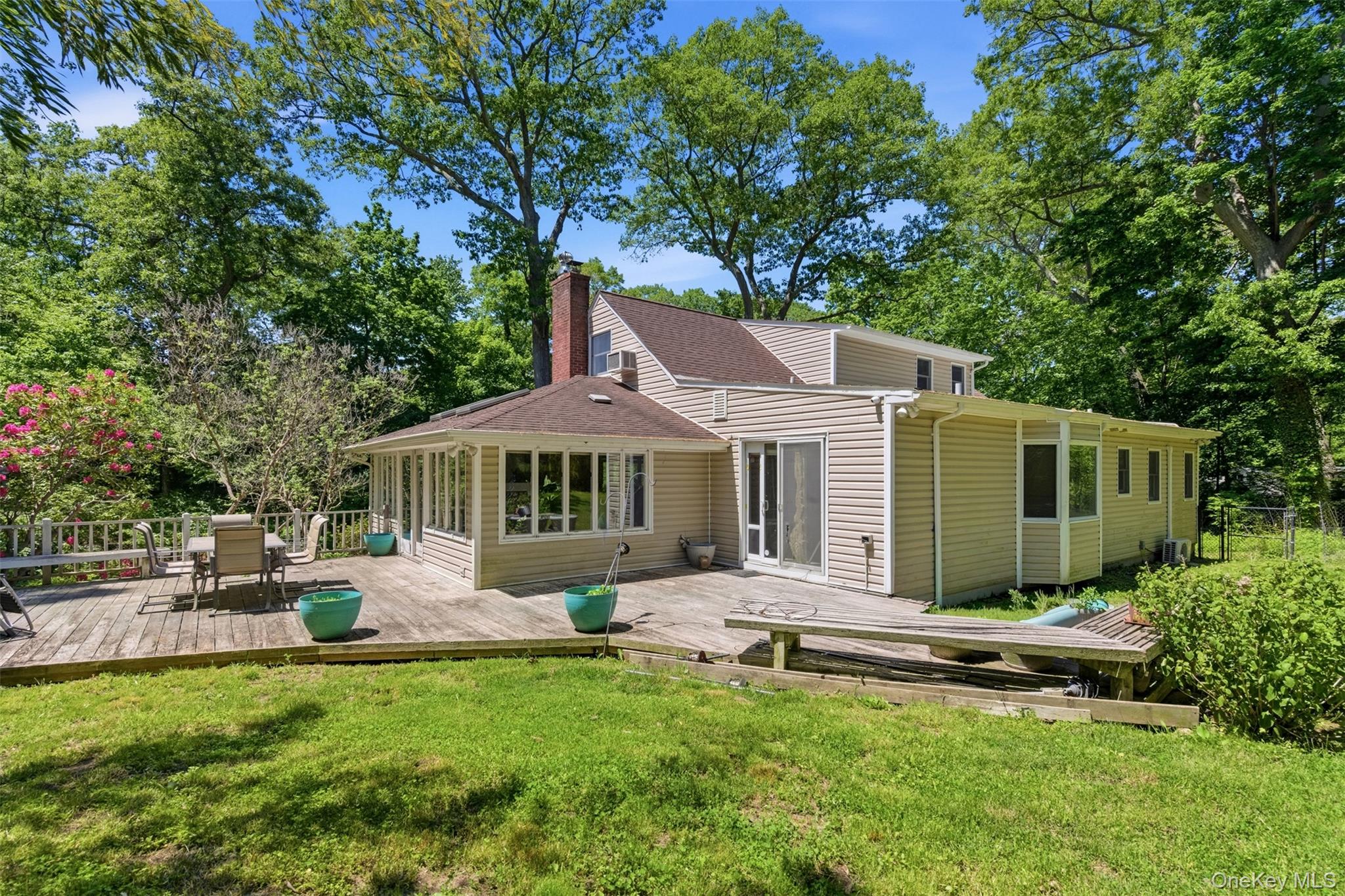 106 Vineyard Road Huntington, NY 11743 - Photo 24 of 25 a front view of a house with a garden and trees