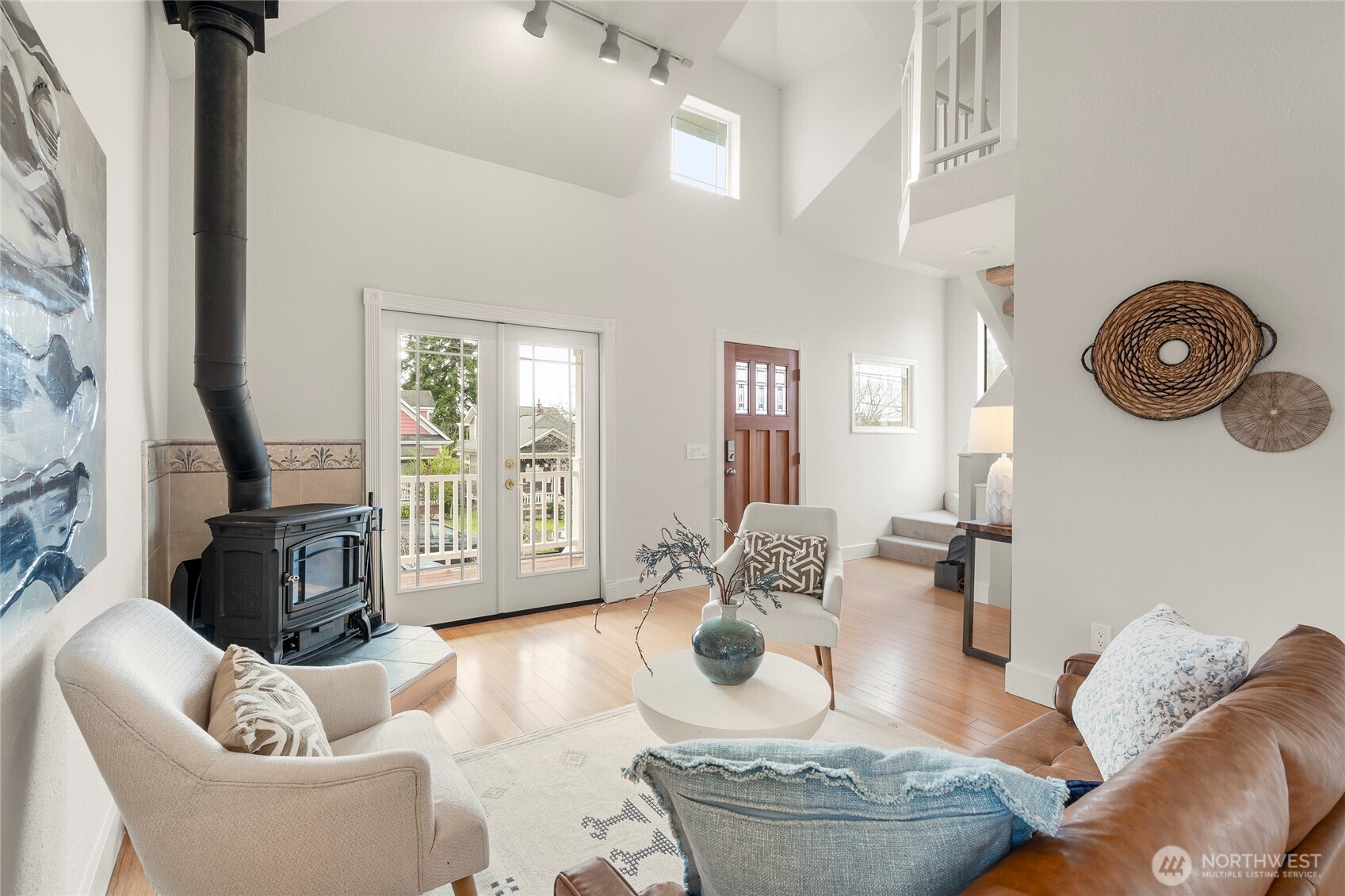 910 Northwest 64th Street Seattle, WA 98107 - Photo 11 of 31 a living room with furniture a flat screen tv and a floor to ceiling window
