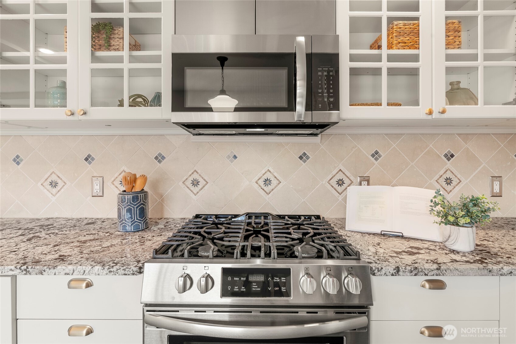 910 Northwest 64th Street Seattle, WA 98107 - Photo 14 of 31 a white stove top oven sitting inside of a kitchen