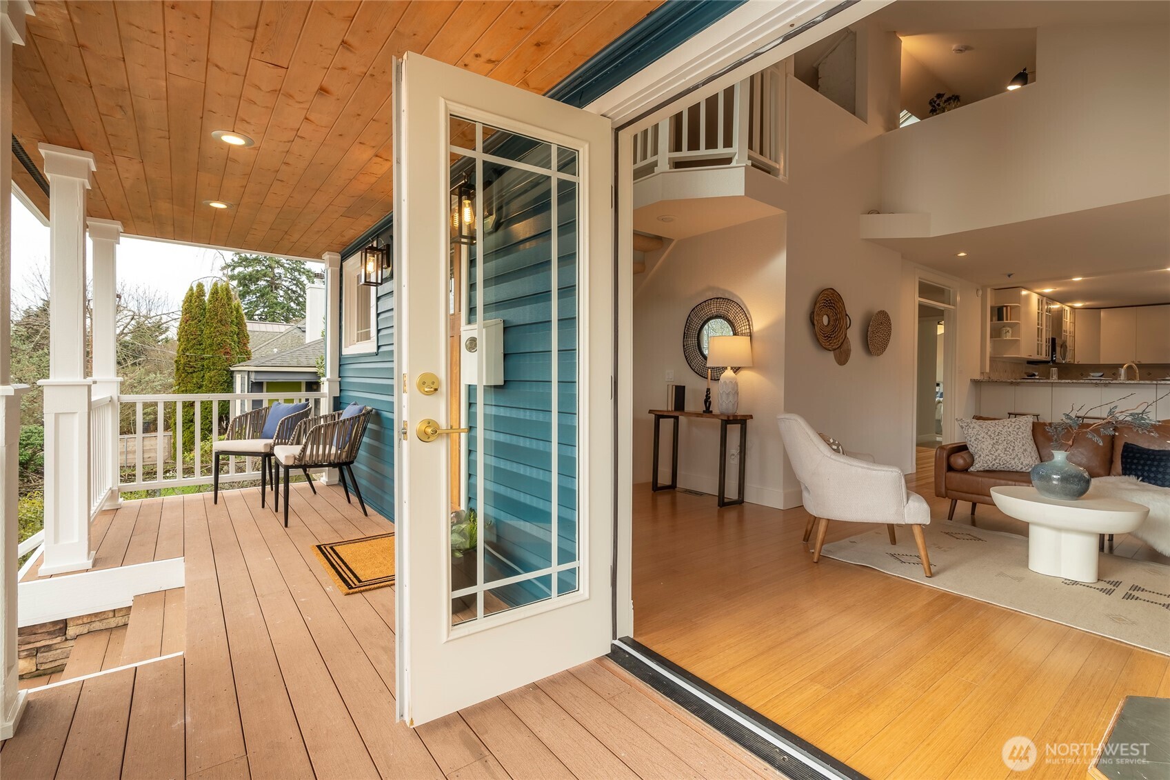 910 Northwest 64th Street Seattle, WA 98107 - Photo 9 of 31 a view of a patio with table and chairs floor to ceiling window with wooden floor