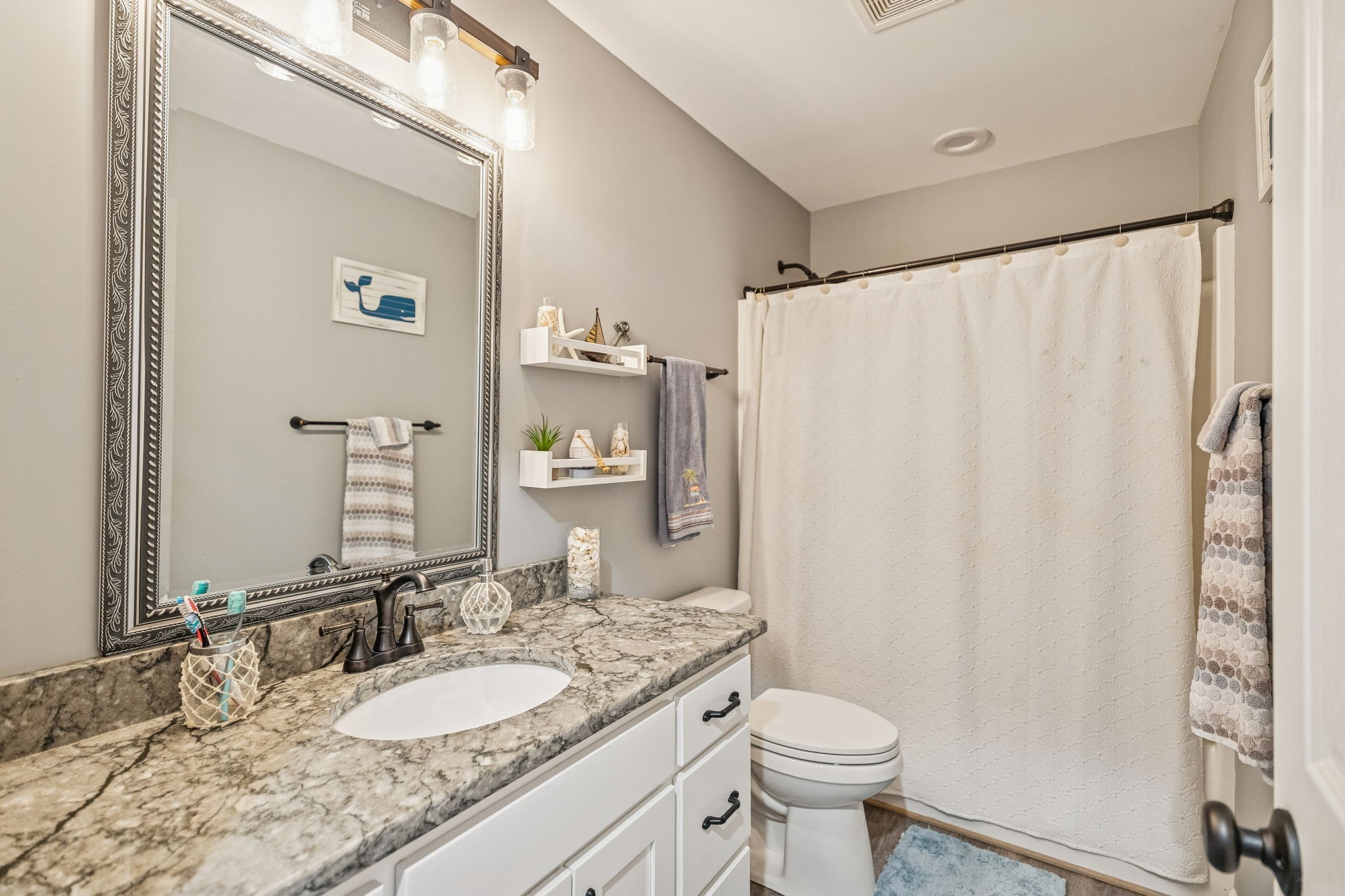 403 Bland Road Estill Springs, TN 37330 - Photo 30 of 66 a bathroom with a granite countertop sink toilet and a mirror