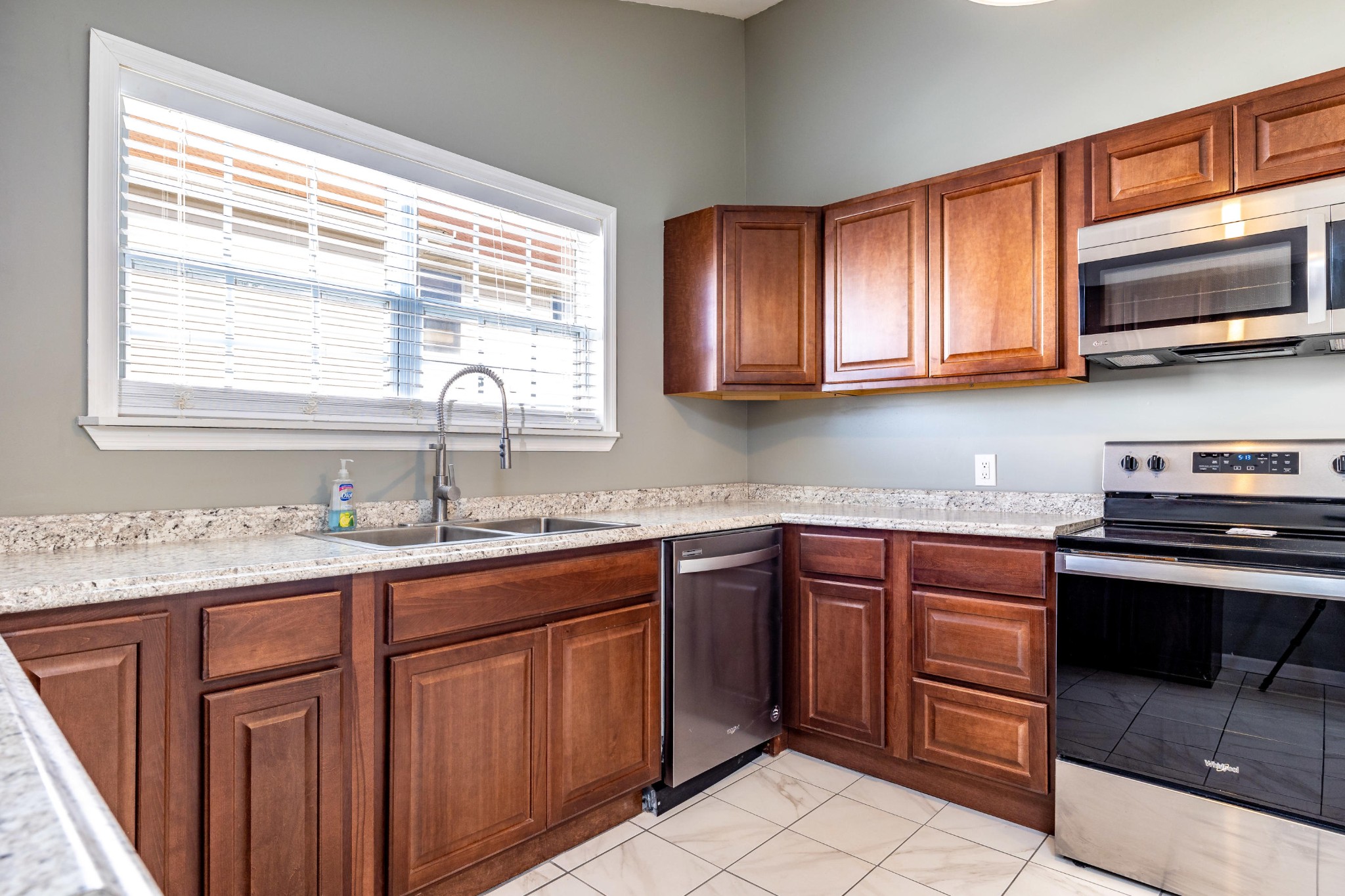804 Spring Street Philadelphia, TN 37846 - Photo 11 of 33 a kitchen with stainless steel appliances granite countertop wooden cabinets and a stove top oven