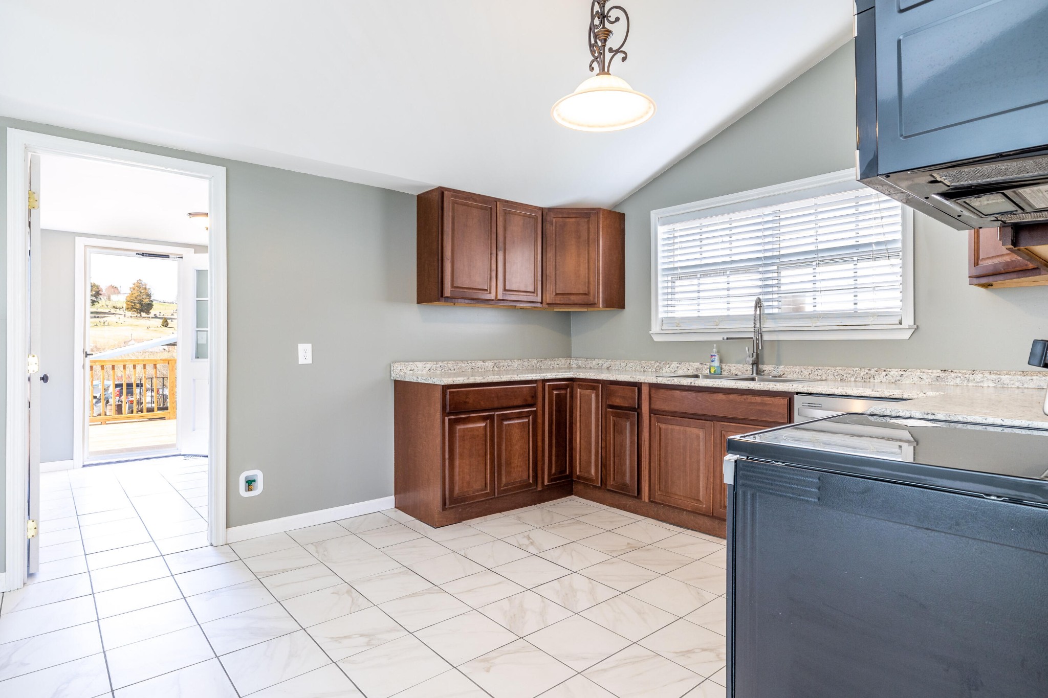 804 Spring Street Philadelphia, TN 37846 - Photo 12 of 33 a kitchen with stainless steel appliances granite countertop a sink and a stove