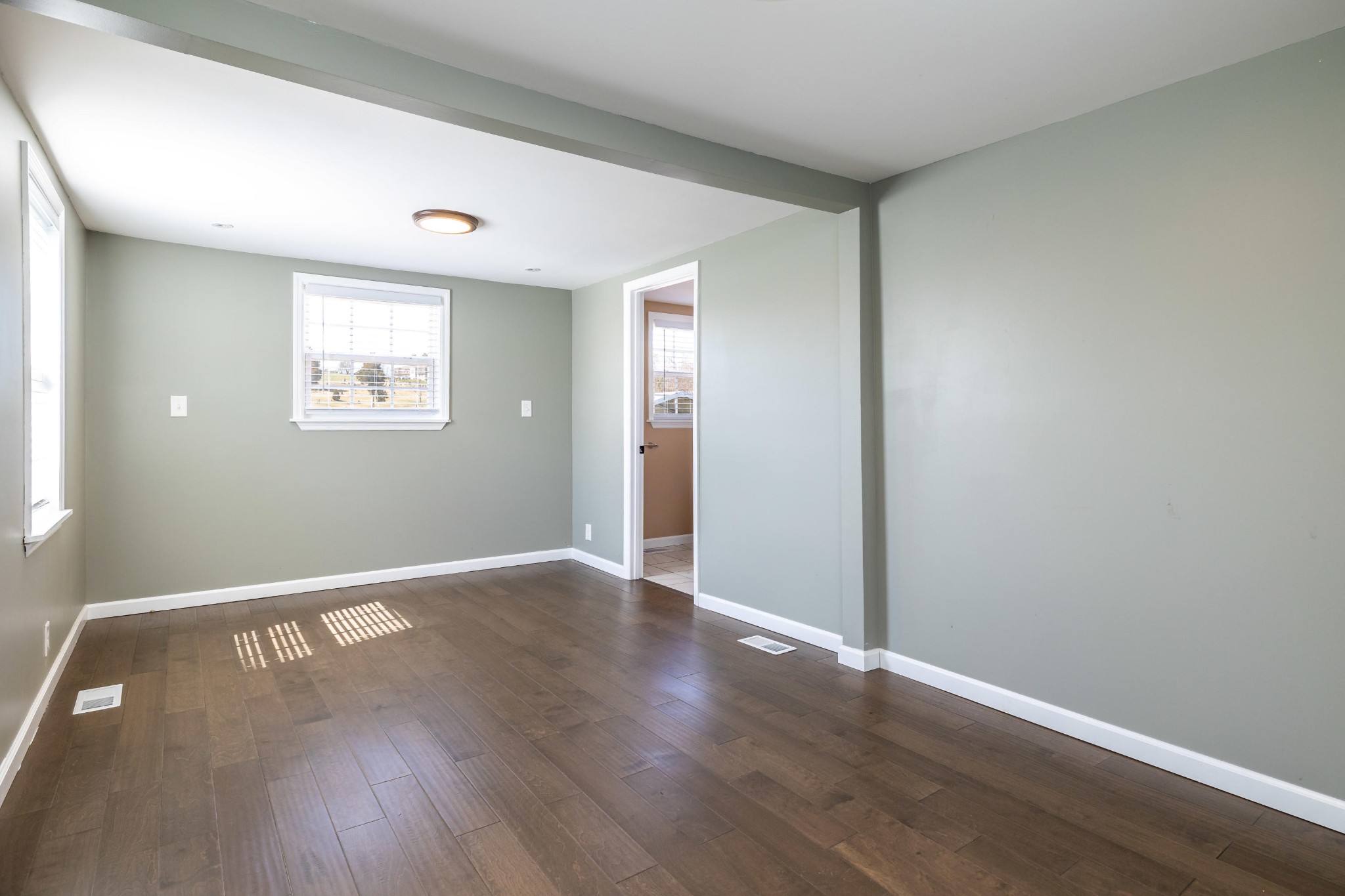 804 Spring Street Philadelphia, TN 37846 - Photo 22 of 33 an empty room with wooden floor and windows