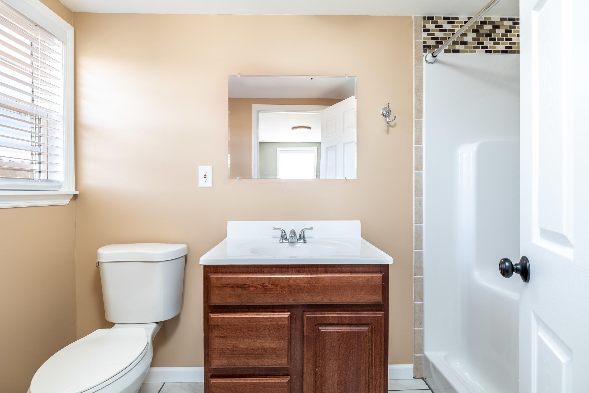 804 Spring Street Philadelphia, TN 37846 - Photo 24 of 33 a bathroom with a toilet a sink and a window