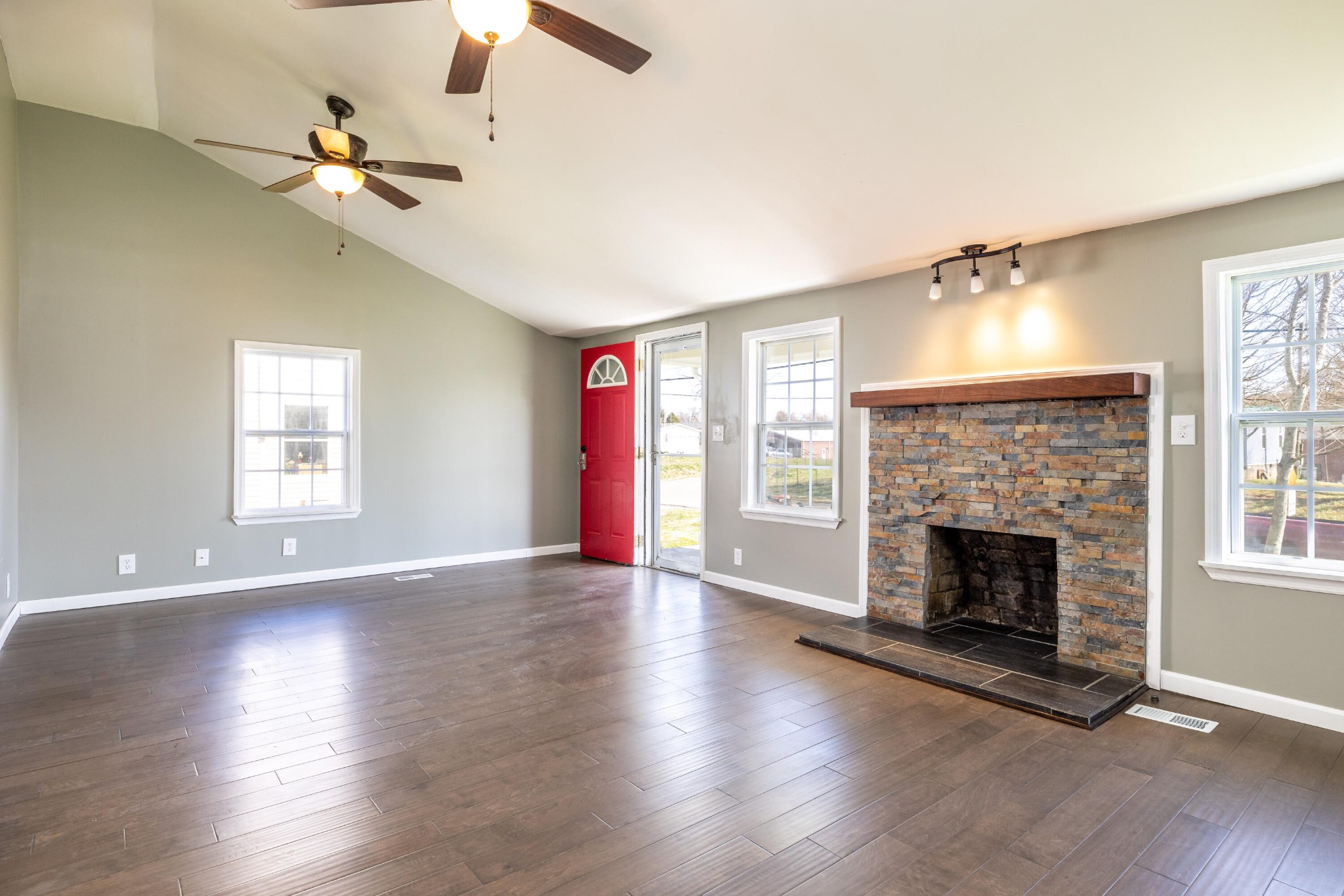 804 Spring Street Philadelphia, TN 37846 - Photo 7 of 33 an empty room with wooden floor fireplace and windows