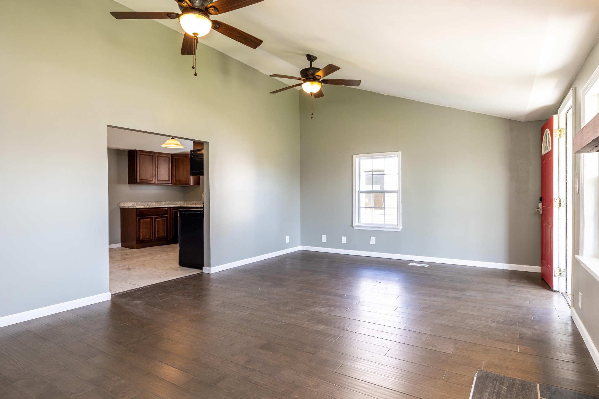 804 Spring Street Philadelphia, TN 37846 - Photo 8 of 33 an empty room with wooden floor chandelier fan and windows