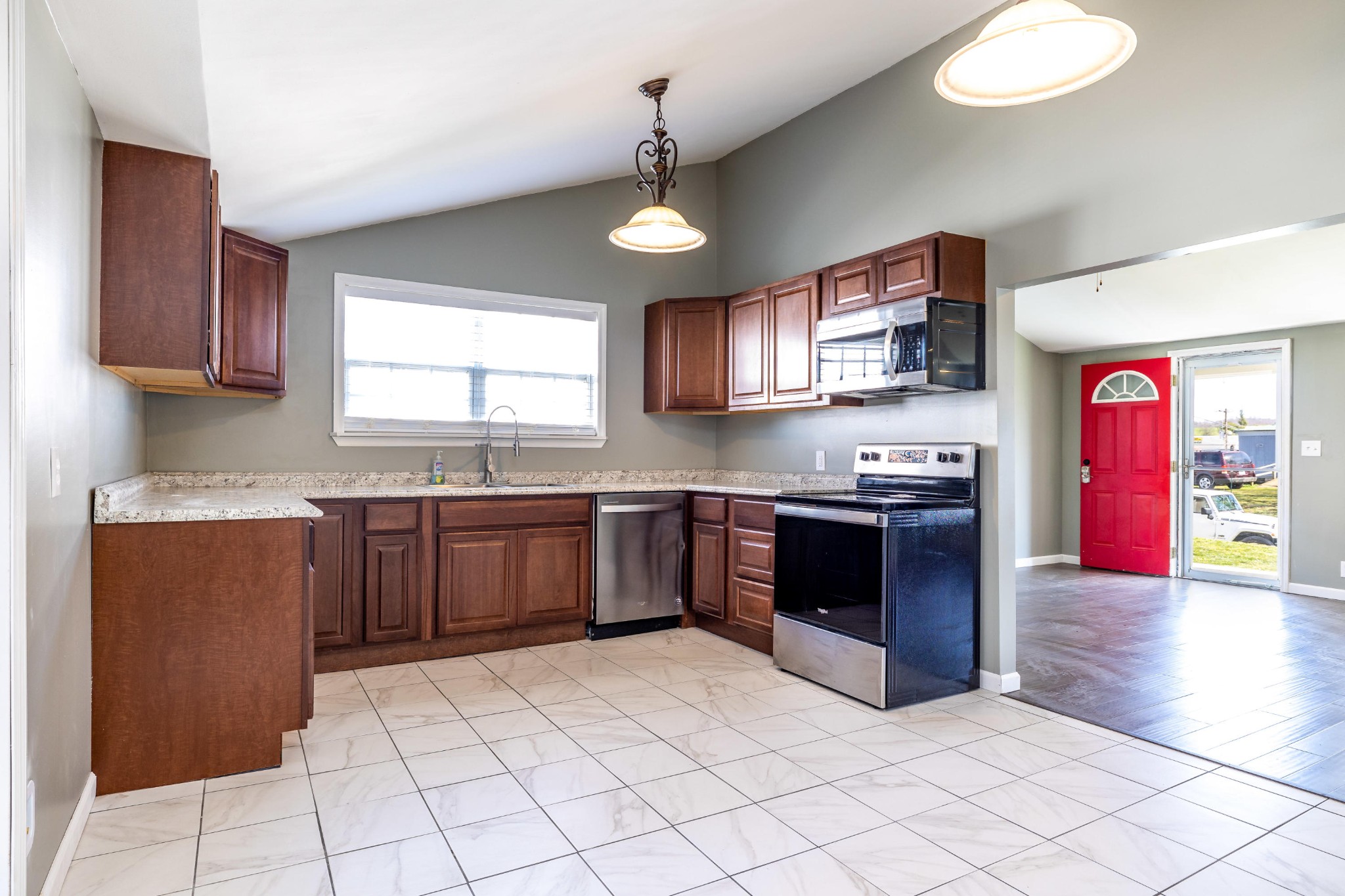 804 Spring Street Philadelphia, TN 37846 - Photo 9 of 33 a kitchen with stainless steel appliances granite countertop a refrigerator a sink dishwasher a stove with wooden cabinets and floor