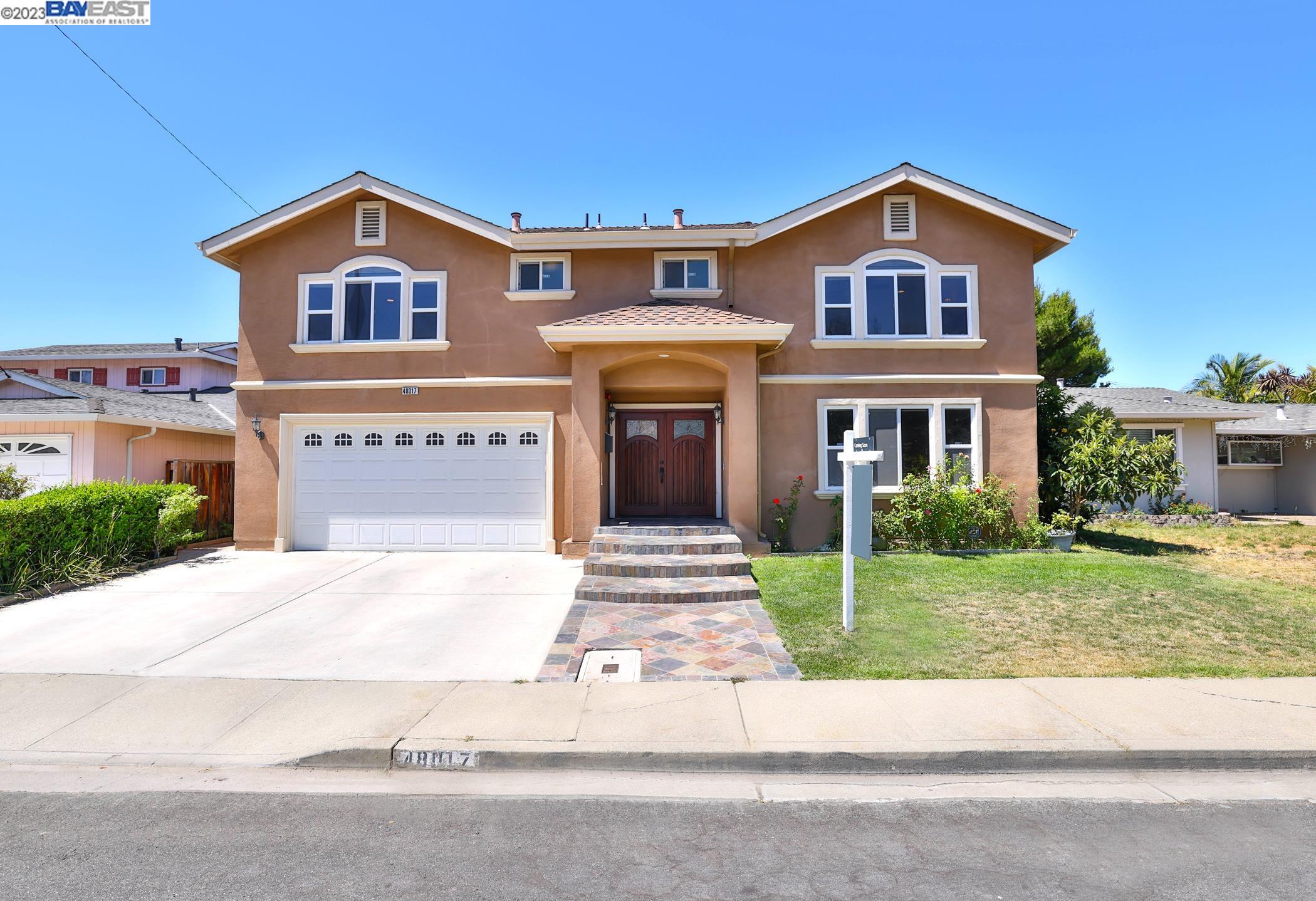 48017 Chann Court Fremont, CA 94539 - Photo 1 of 1 a front view of a house with a garden
