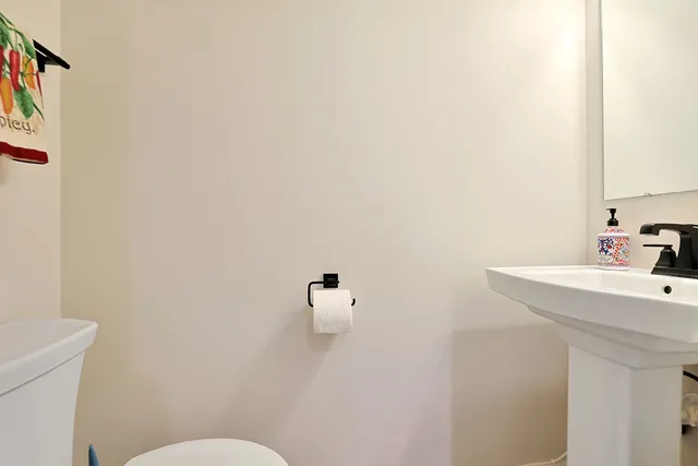 a bathroom with a sink a toilet and mirror