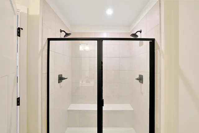 a bathroom with a shower and a glass door