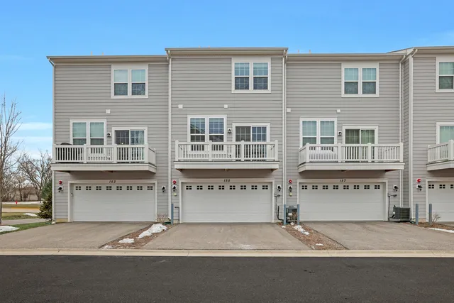 a front view of a house with a parking and garage