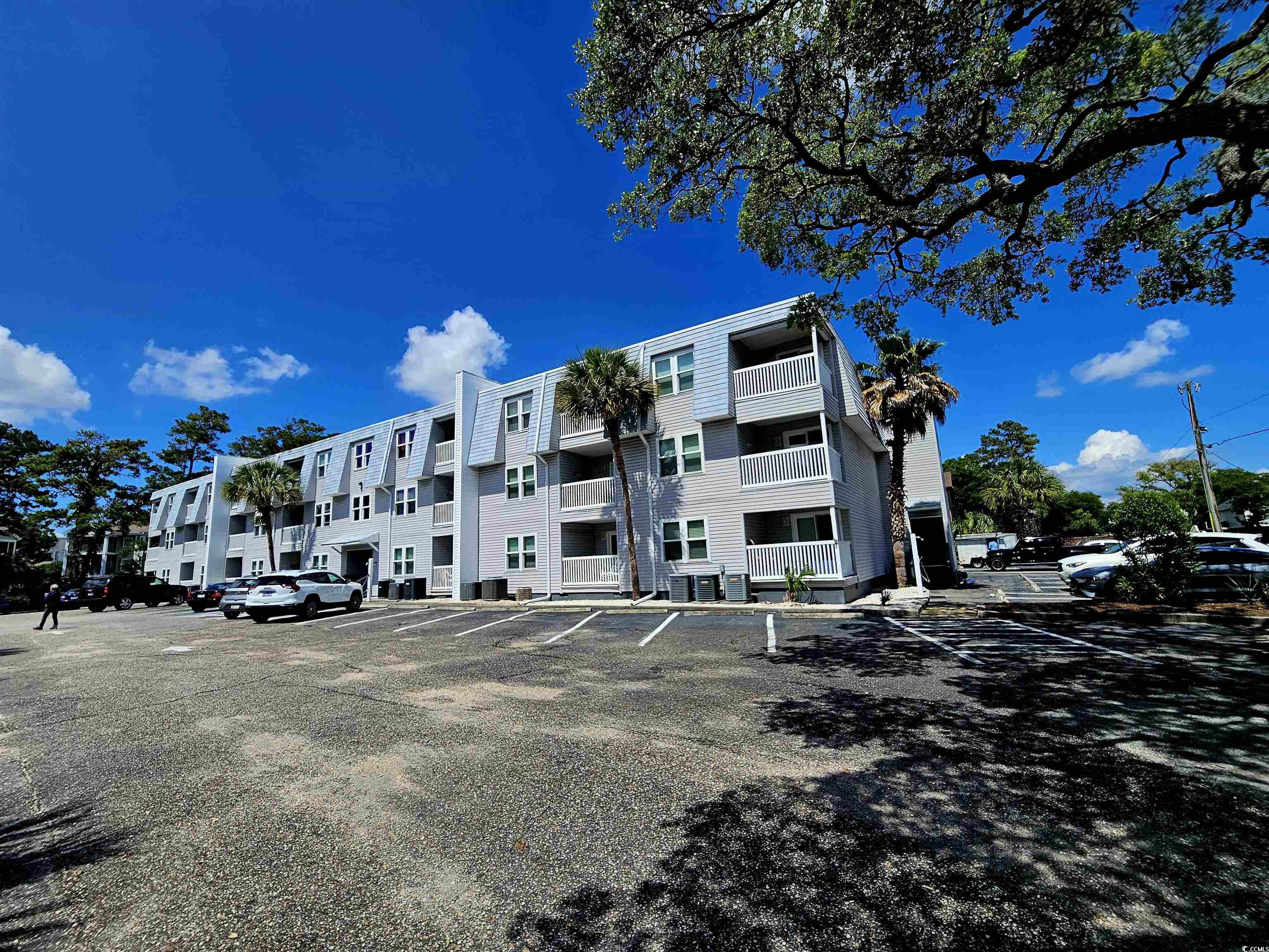 View of property featuring uncovered parking