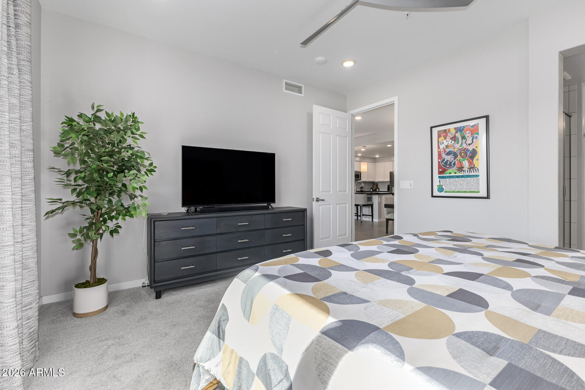 250 West Queen Creek Road, Unit 144 Chandler, AZ 85248 - Photo 12 of 33 a bedroom with a bed and a flat screen tv
