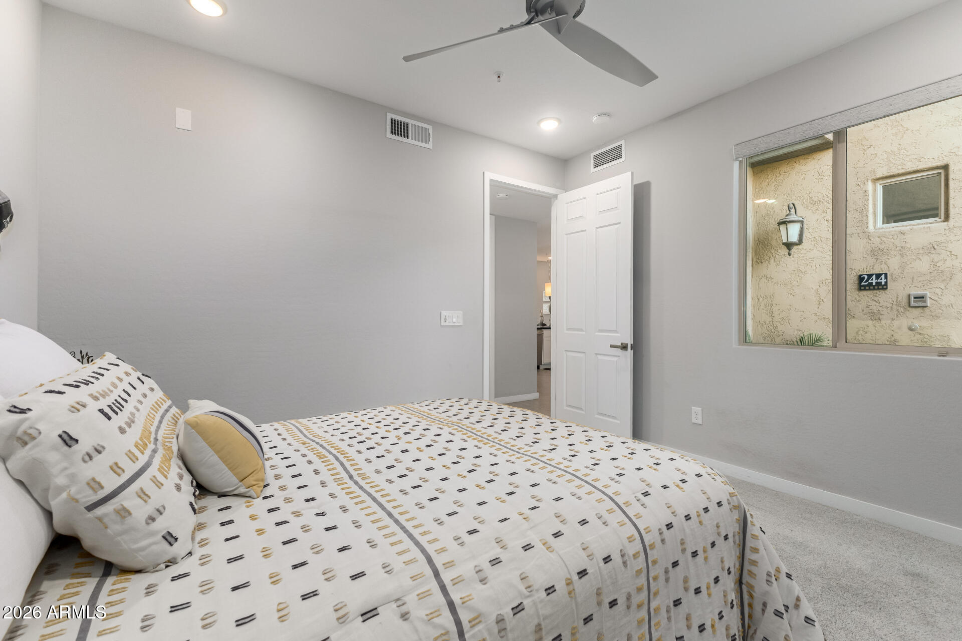 250 West Queen Creek Road, Unit 144 Chandler, AZ 85248 - Photo 17 of 33 a bedroom with a bed and a window