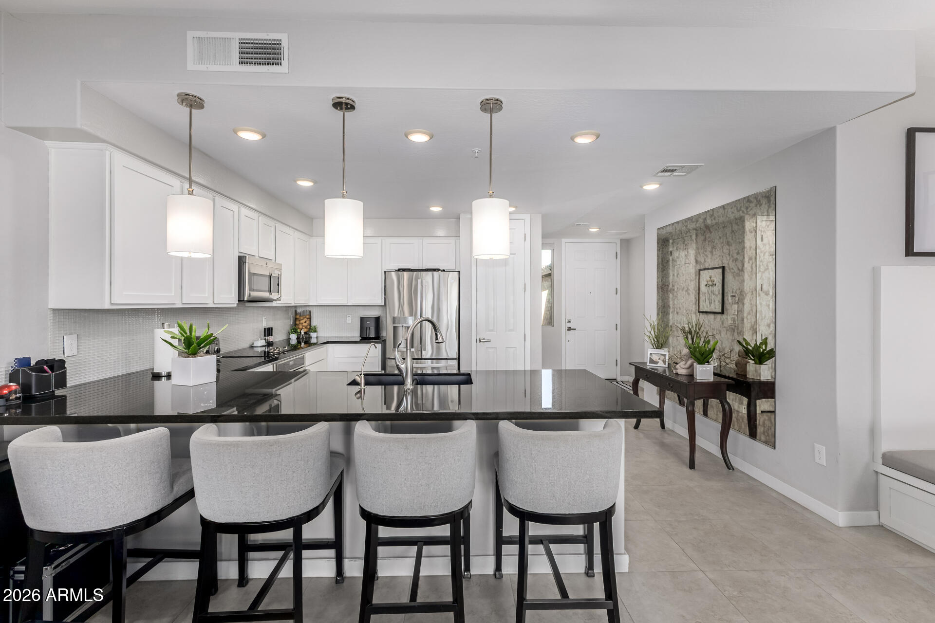 250 West Queen Creek Road, Unit 144 Chandler, AZ 85248 - Photo 8 of 33 a kitchen with a dining table chairs and view living room