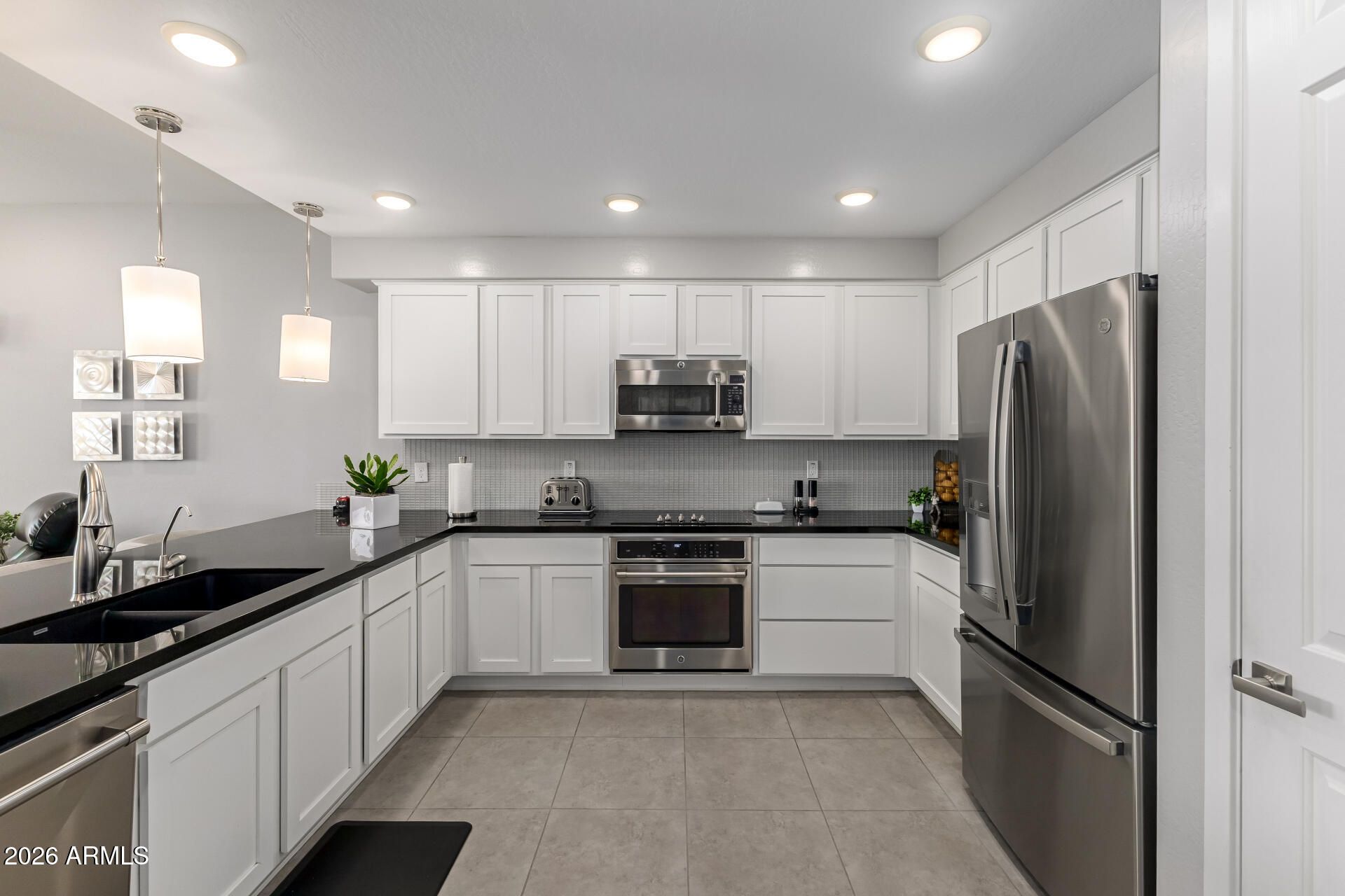 250 West Queen Creek Road, Unit 144 Chandler, AZ 85248 - Photo 9 of 33 a kitchen with stainless steel appliances granite countertop a refrigerator sink and stove