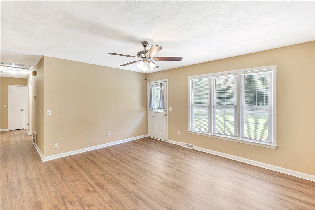 2011 Forest Drive Seneca, SC 29672 - Photo 18 of 36 Natural light floods this inviting living space, complete with durable flooring and a ceiling fan.