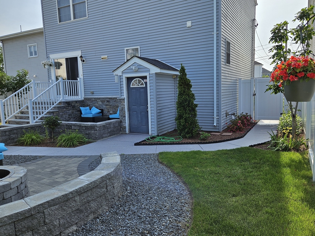 33 Barclay Street Fall River, MA 02724 - Photo 17 of 37 a front view of a house with a yard and potted plants