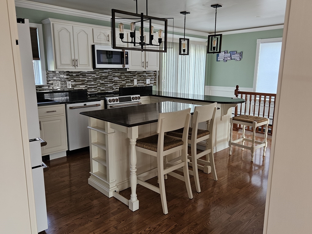 33 Barclay Street Fall River, MA 02724 - Photo 32 of 37 a kitchen with stainless steel appliances kitchen island granite countertop a stove a sink and a refrigerator