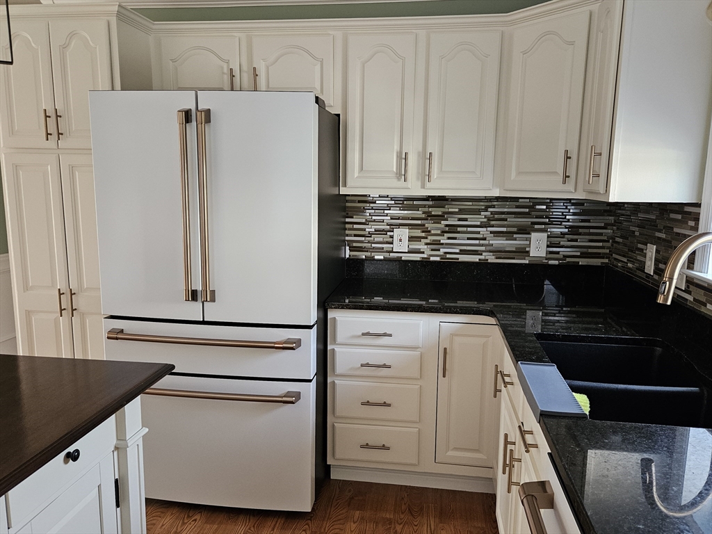 33 Barclay Street Fall River, MA 02724 - Photo 33 of 37 a kitchen with white cabinets and black appliances