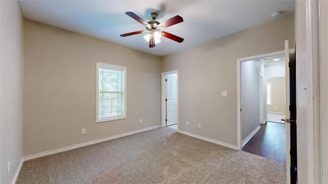 a bathroom with a granite countertop toilet sink and mirror