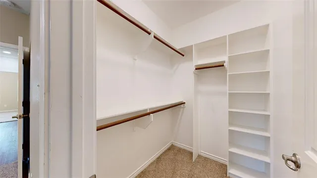 an empty room with closet and a ceiling fan