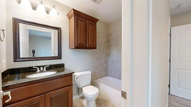 a view of an empty room with a ceiling fan